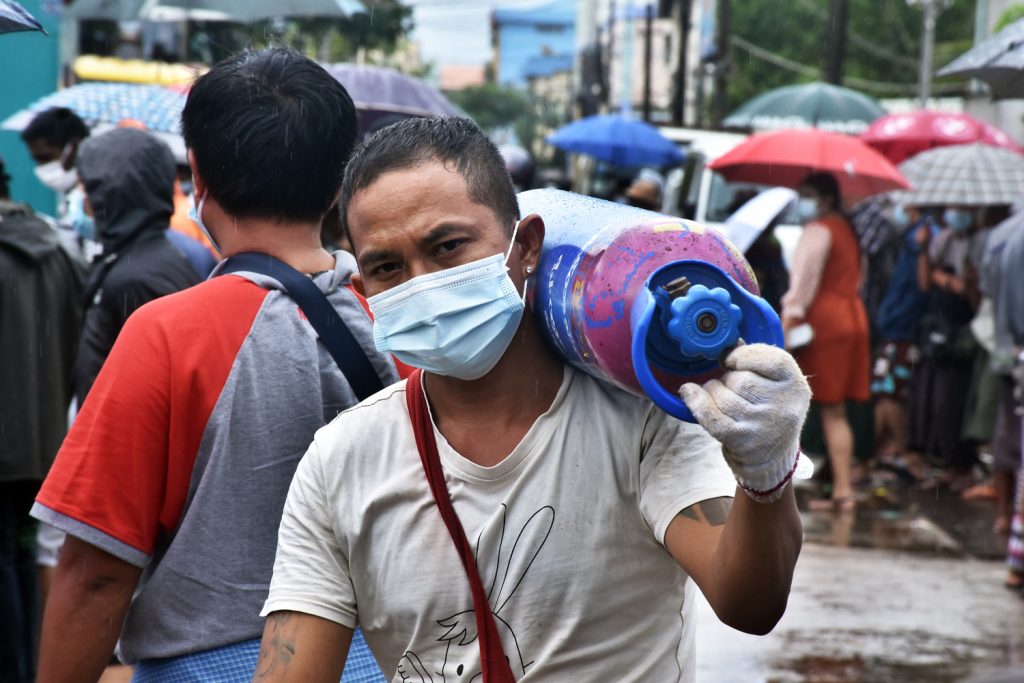 A man carries an oxygen cylinder outside the Matesat factory in South Dagon Township on July 13. (Frontier)