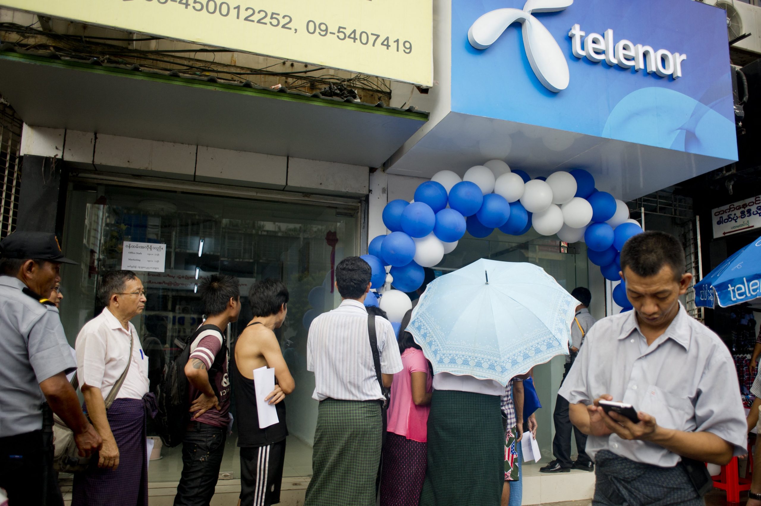 People line up to buy Telenor SIM cards in Yangon in October 2014, just after the company launched in Myanmar (AFP)