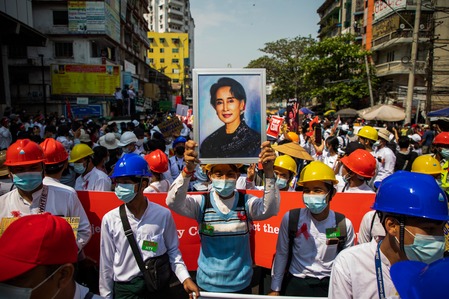 A protester holds a painting of Aung San Suu Kyi in Yangon during a demonstration against the junta in Yangon in February 2021. (Frontier)