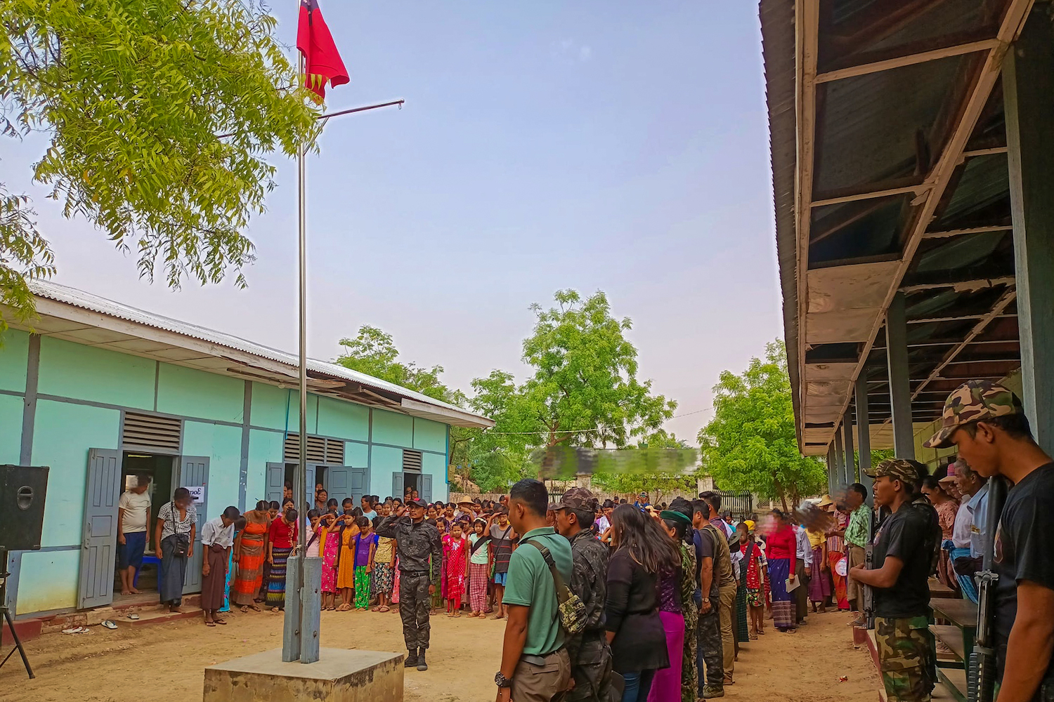 People's Defence Force fighters stand guard during the opening ceremony for a school in Sagaing Region's Myaung Township in April. (Supplied)