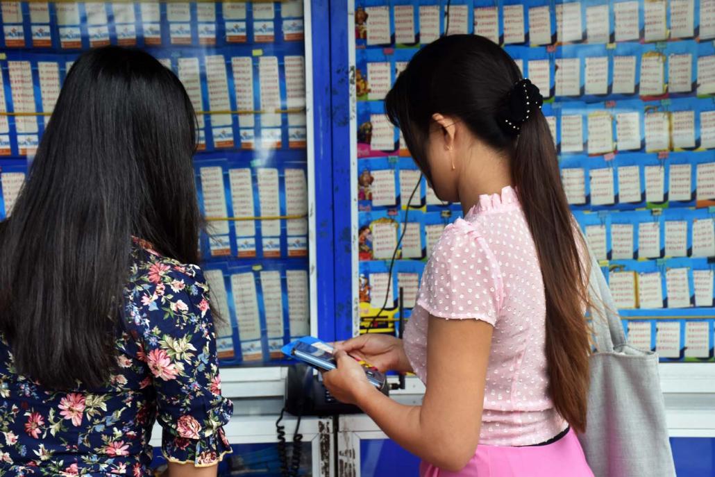 Customers buy lottery tickets in Yangon before the coup. (Frontier)