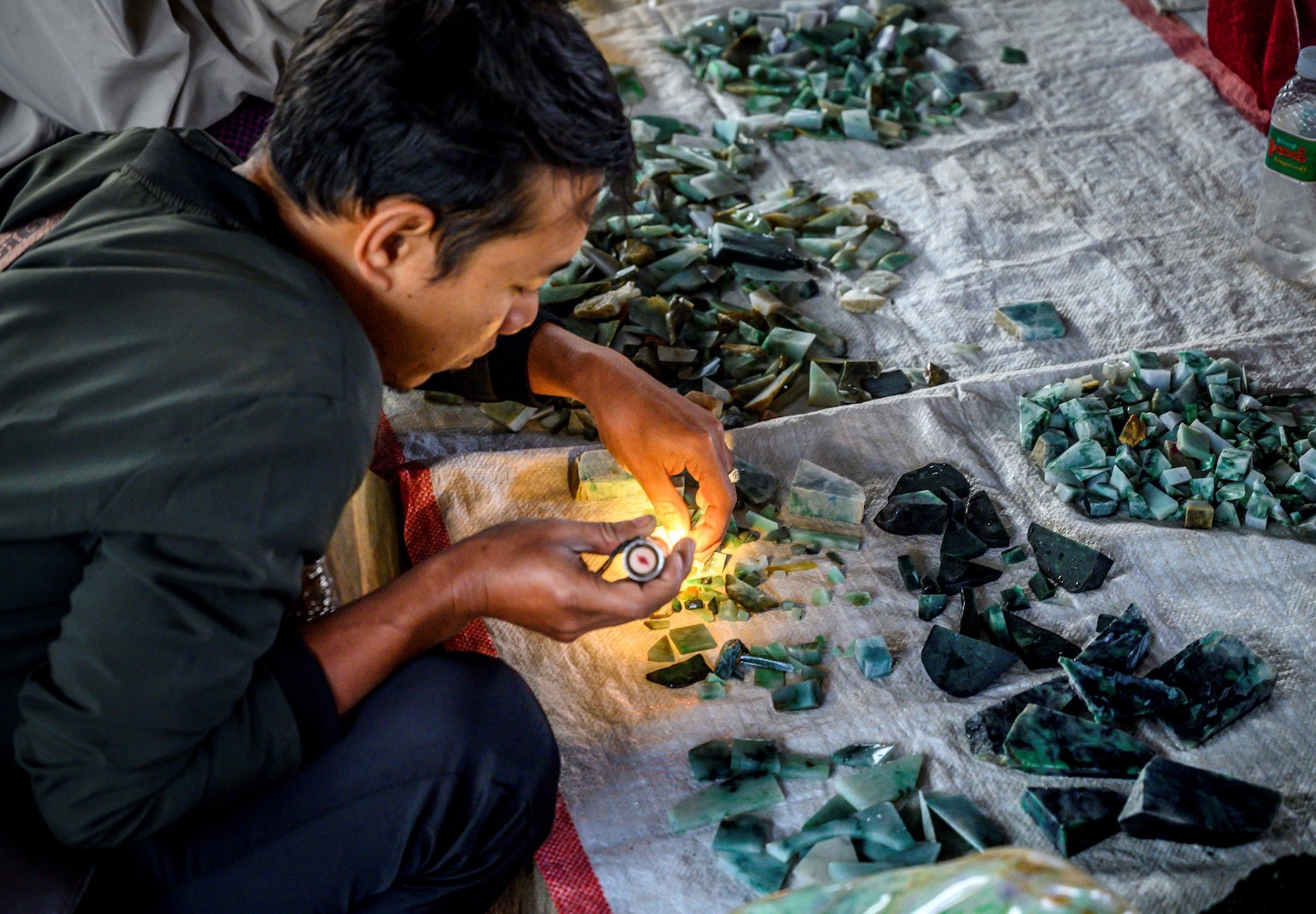 A man examining jade at Mandalay's famous Jade and Amber market in 2020. (AFP)