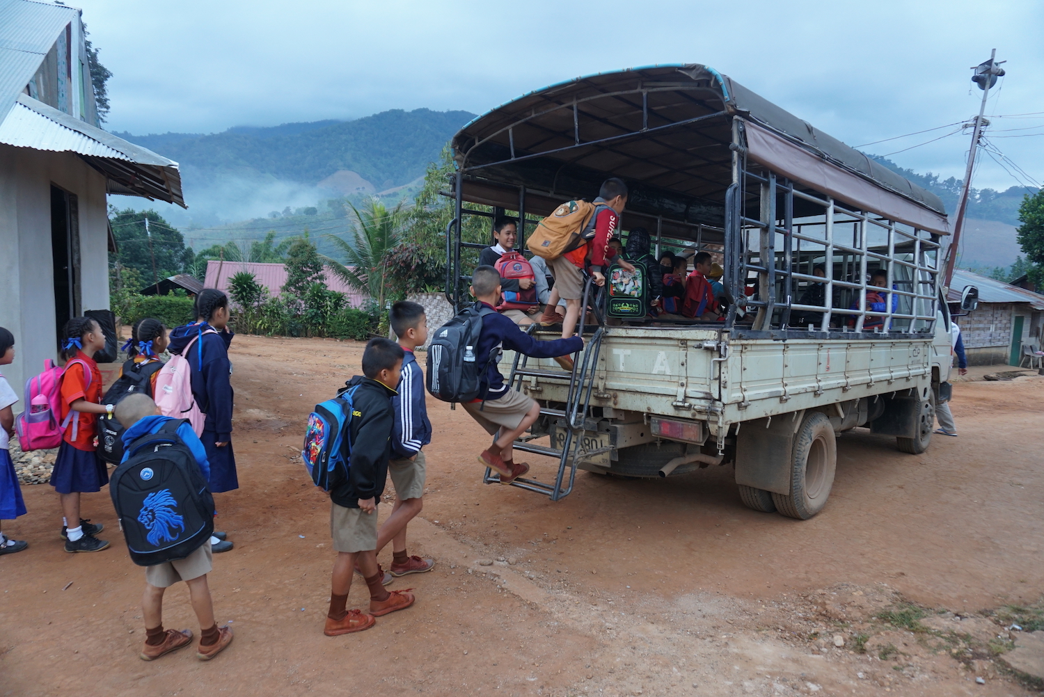 Shan refugee children pile into the back of a truck to attend Thai public schools. (Frontier)