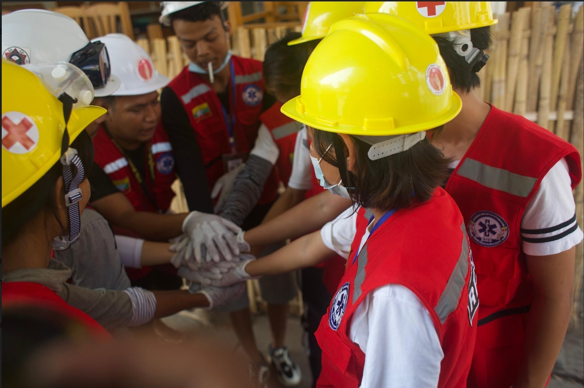 Volunteer rescue workers huddle in Yangon's Sanchaung Township. (Frontier)