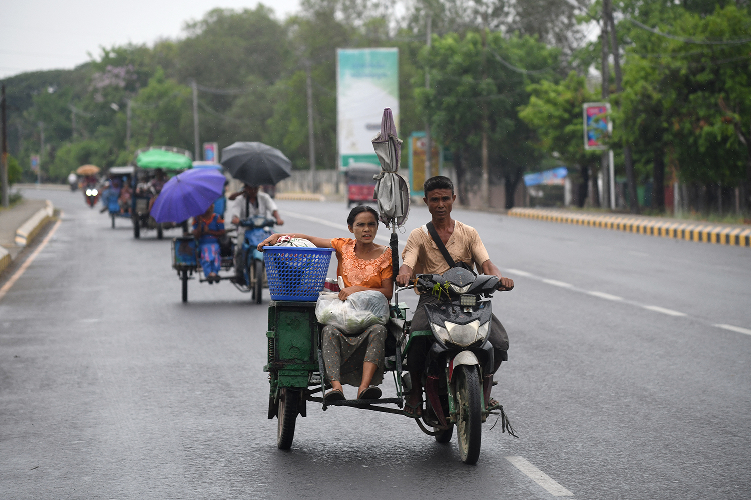 People evacuate in Sittwe, capital of Rakhine State on May 13, 2023, ahead of the landfall of Cyclone Mocha. (AFP)