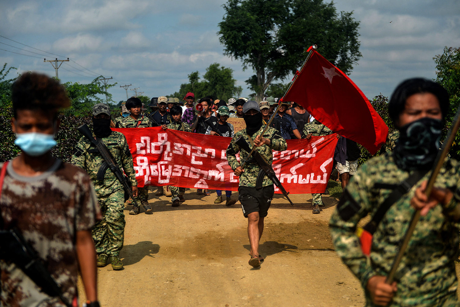 Anti-coup fighters escort protesters as they take part in a demonstration against the military coup in Sagaing Region on September 7, 2022. (AFP)