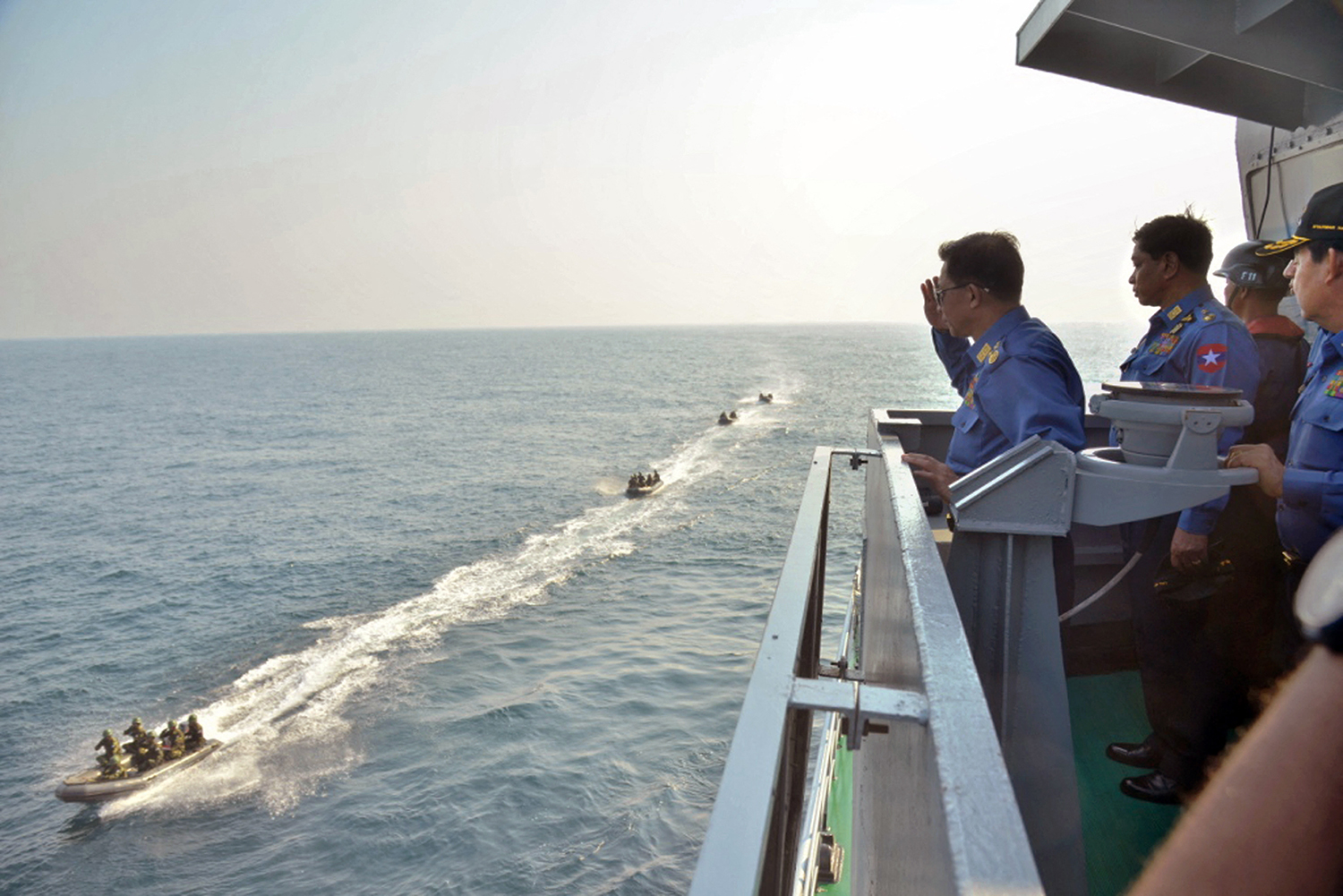 Senior General Min Aung Hlaing salutes to navy commandos from the deck of a warship during the Sea Shield 2016 combined fleet exercise off the Coco Islands in the Andaman Sea on February 27, 2016. (AFP)