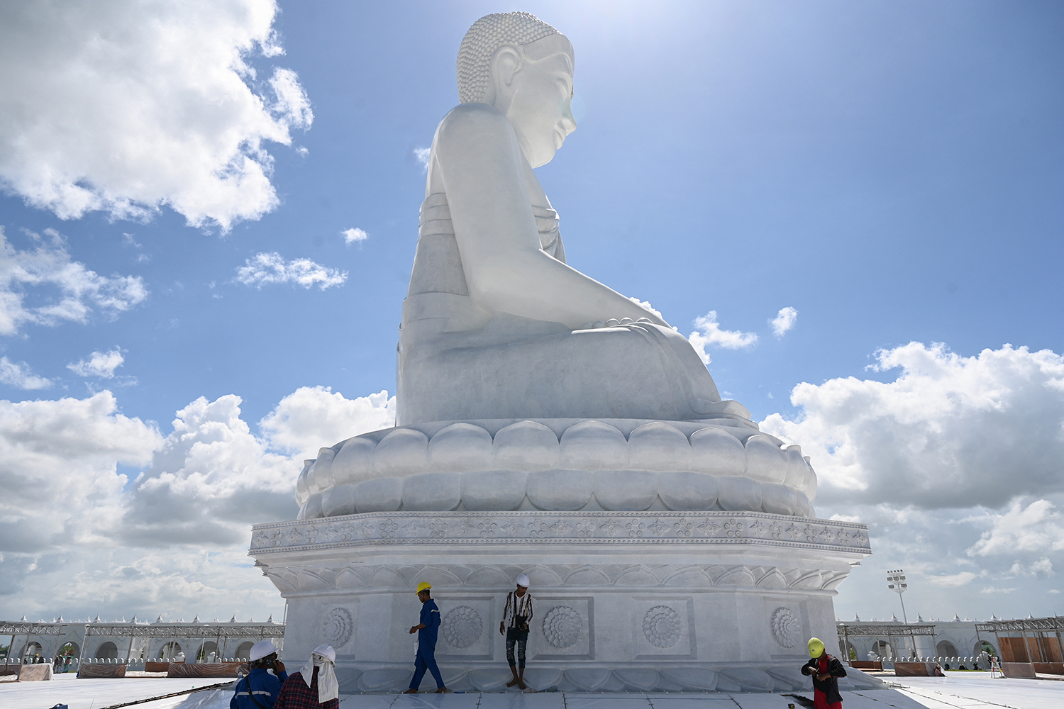 Workers clean the floor around the marble Maravijaya statue, the tallest sitting Buddha in the world, in Nay Pi Taw on July 21, ahead of its opening on August 2. (AFP)