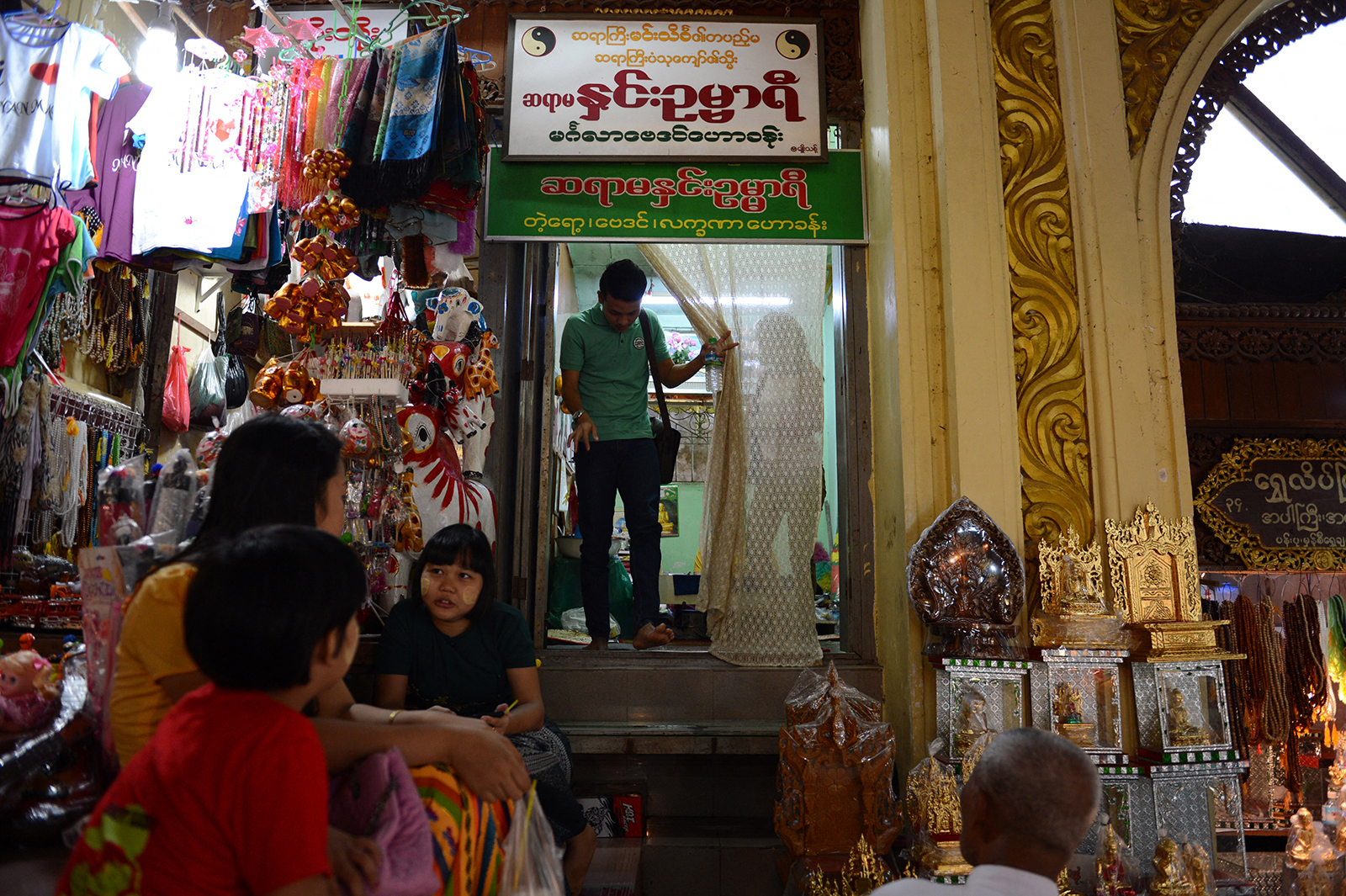 A couple exits the shop of a well-known fortune teller in Yangon’s Shwedagon Pagoda on November 7, 2015. (AFP)