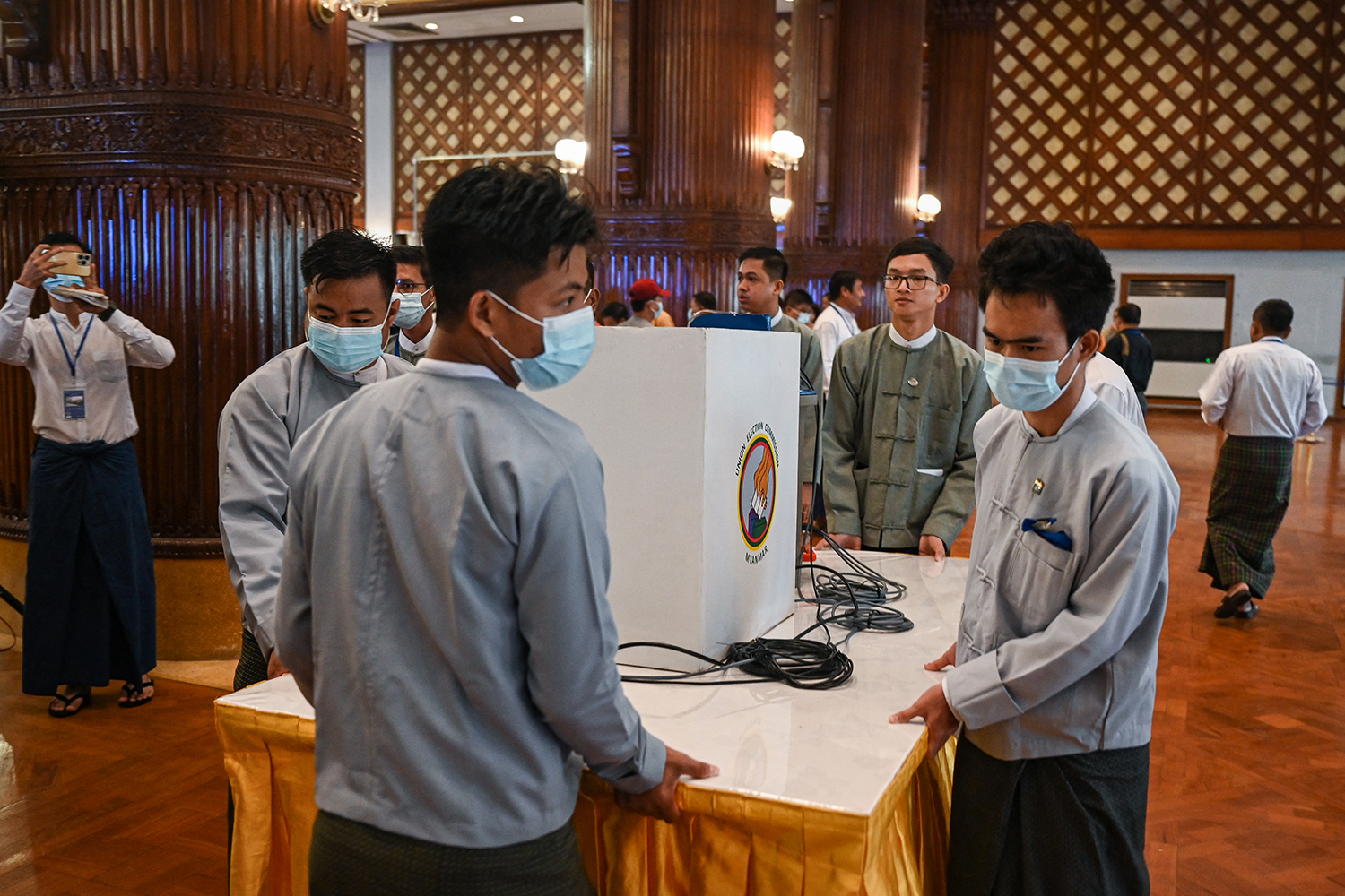 Members of the junta-stacked Union Election Commission prepare for a demonstration of voting machines in Yangon on September 5. (AFP)