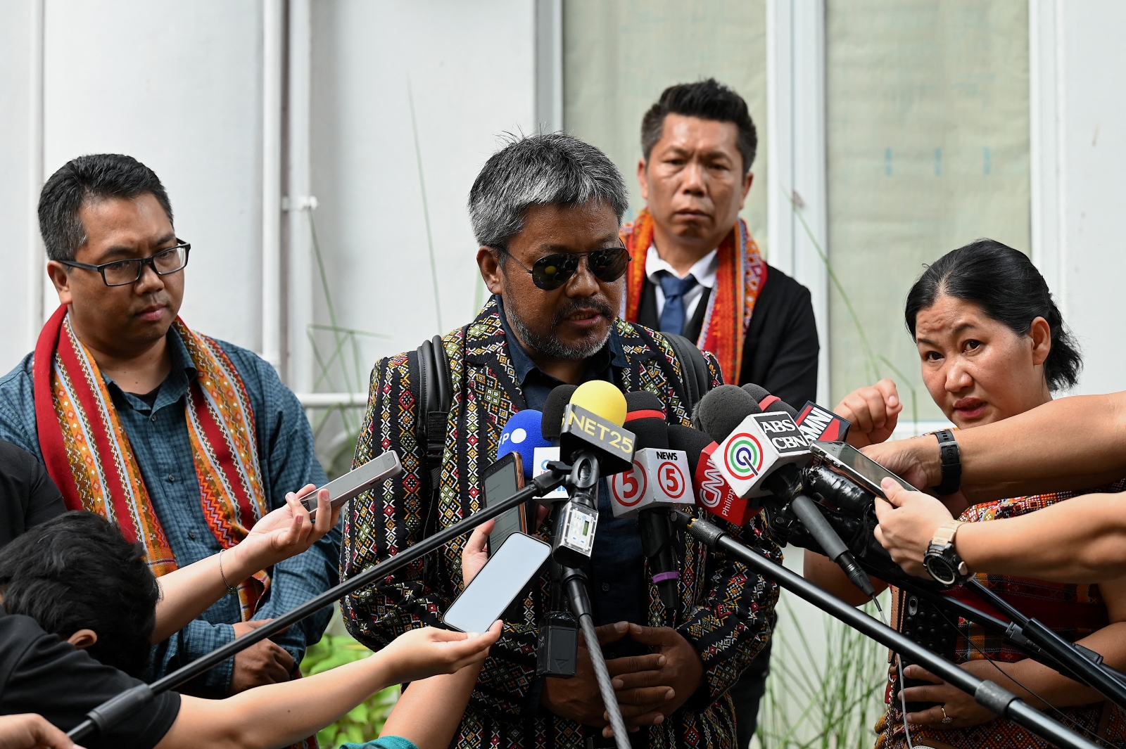 A group of Myanmar nationals speak to the press after filing a criminal complaint against 10 members of the junta at the Department of Justice in Manila on October 25. (AFP)