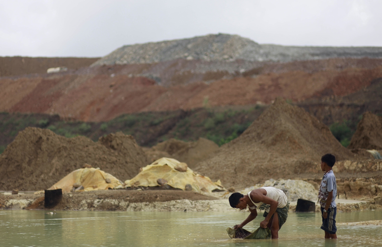 Villagers pan for copper near the Letpadaung mine in Sagaing Region’s Salingyi Township on September 14, 2012. Operations have been halted at the mine due to instability since the coup, contributing to an 80 percent drop in earnings from mining exports between 2020 and 2022. (AFP)