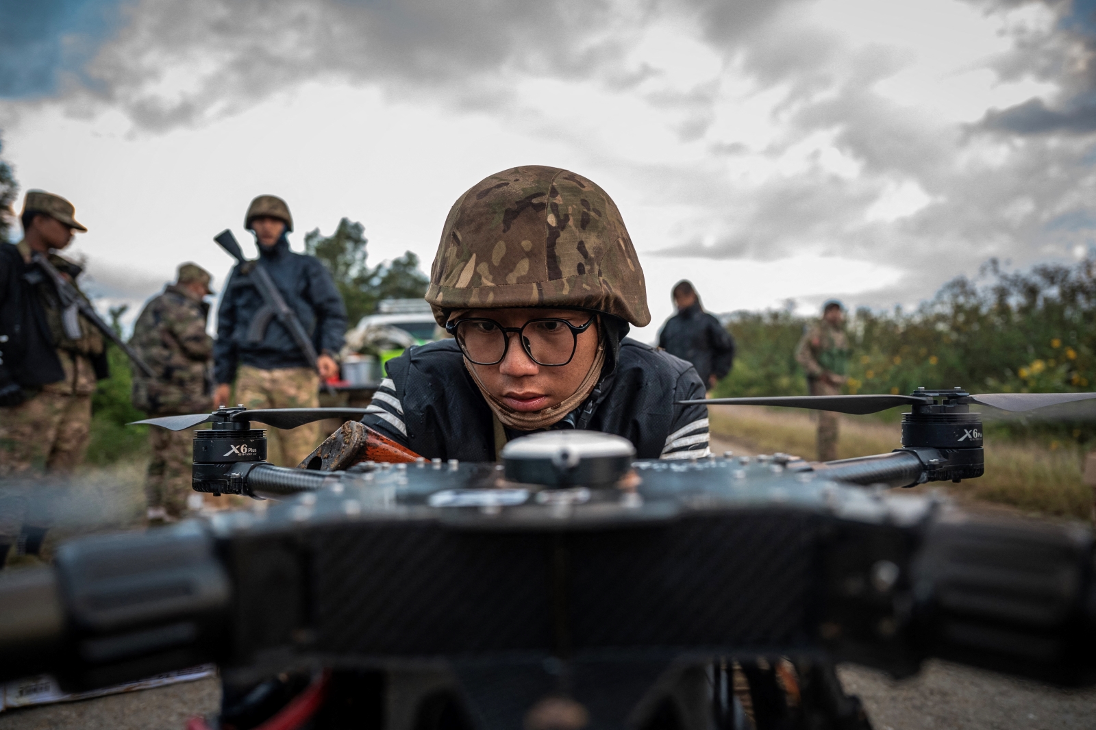 A member of the Mandalay People’s Defense Force prepares to release a drone near the frontline amid clashes with the Myanmar military in northern Shan State on December 11, 2023. (AFP)