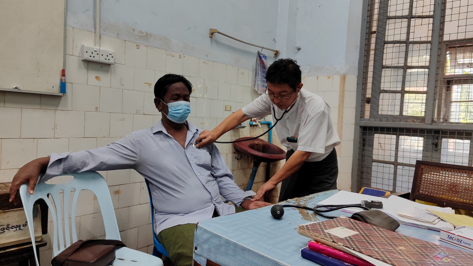 A leprosy inspector checks a patient at Yangon General Hospital’s special skin clinic on October 25. (Moe Thaw Dar Swe | Frontier)