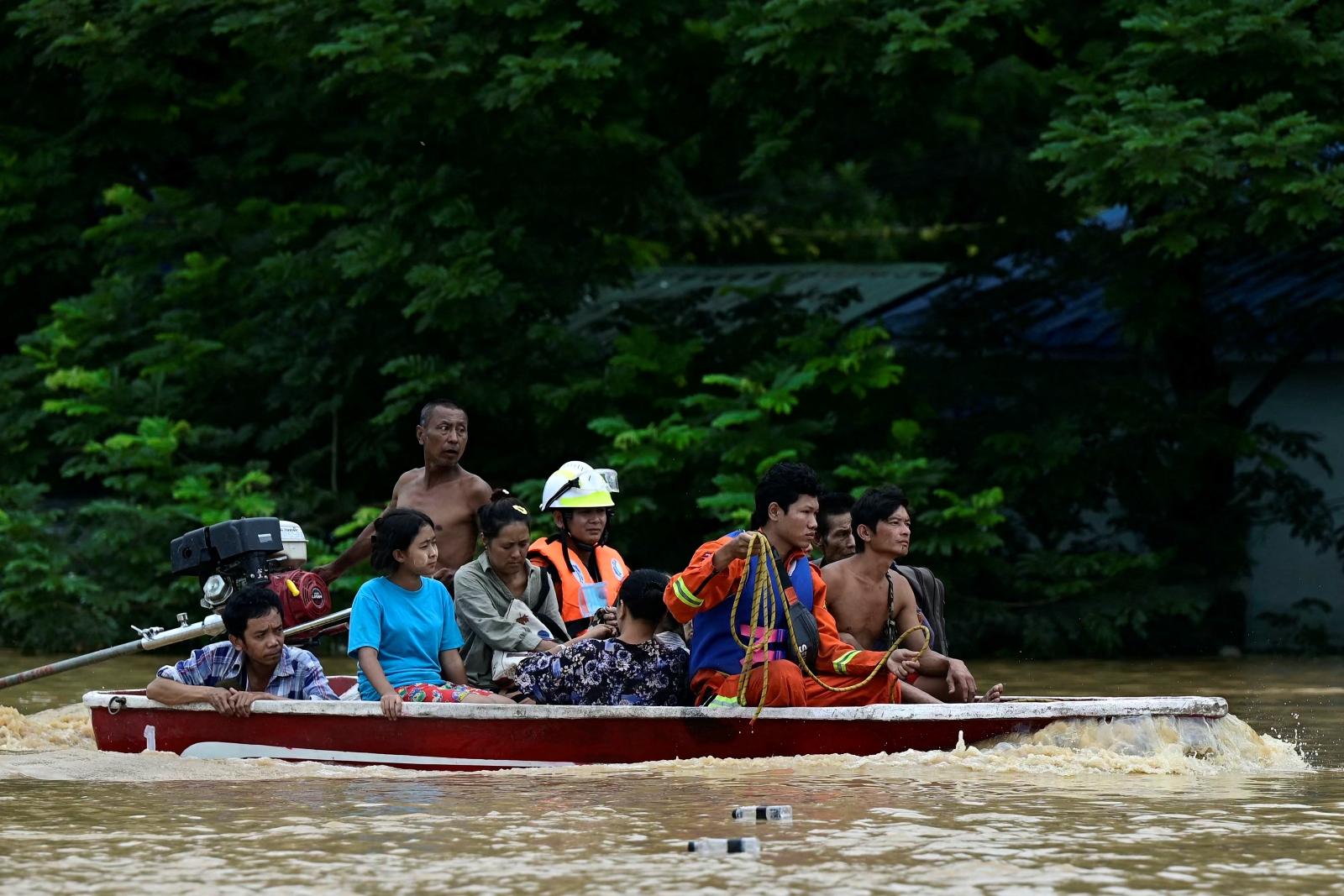 Flood-affected residents are transported on a rescue boat in Bago Region’s Taungoo Township on September 14. (AFP)