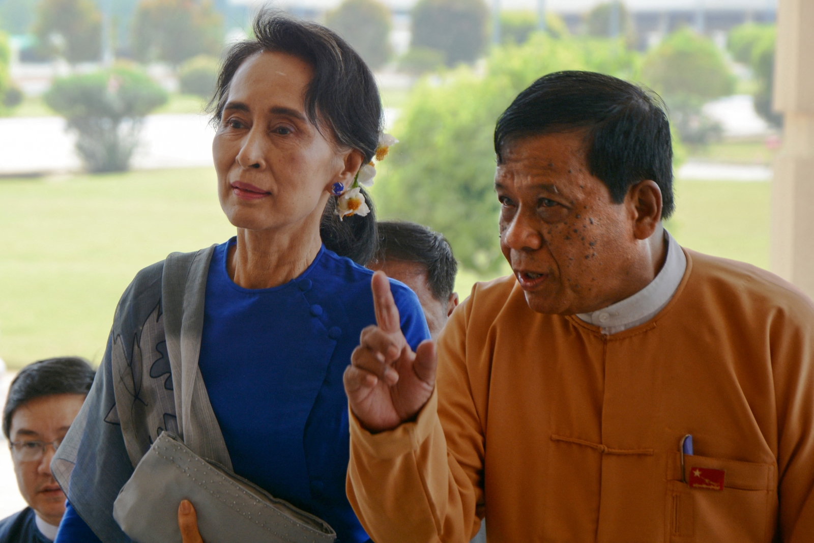 Zaw Myint Maung escorts Aung San Suu Kyi during her arrival at the parliament in Nay Pyi Taw on March 1, 2016. (AFP)