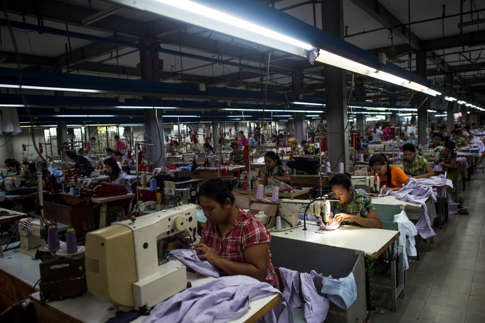 Workers sew at a garment factory in Yangon on November 1, 2018. (AFP)