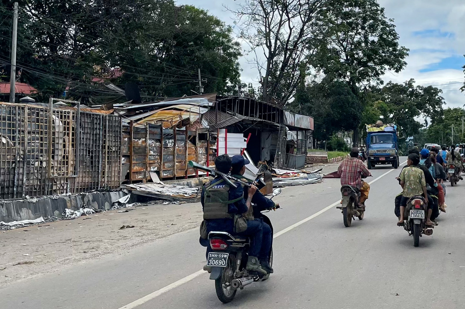 Members of the police force of the Myanmar National Democratic Alliance Army ride on a motorcycle in northern Shan State’s Lashio town on August 10. (AFP)