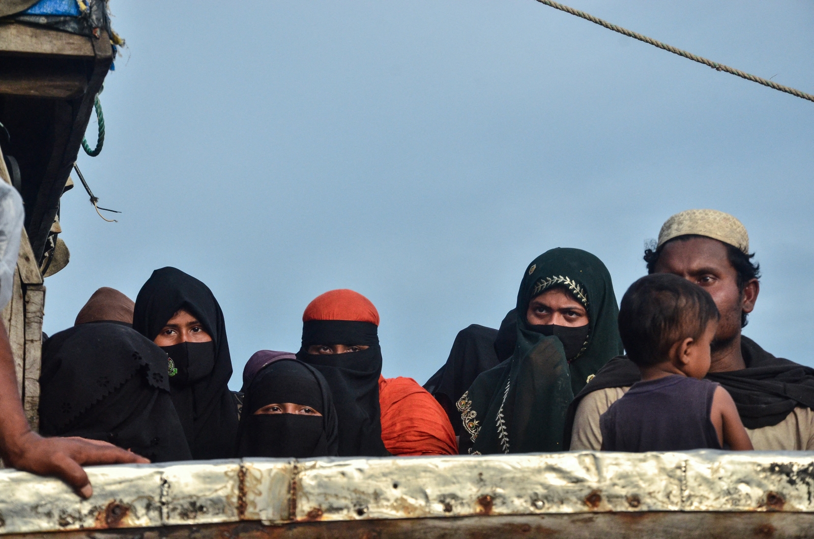 Rohingya refugees look on from their boat after authorities prevented them from disembarking at Leuge Beach in Indonesia's Aceh province yesterday. (AFP)