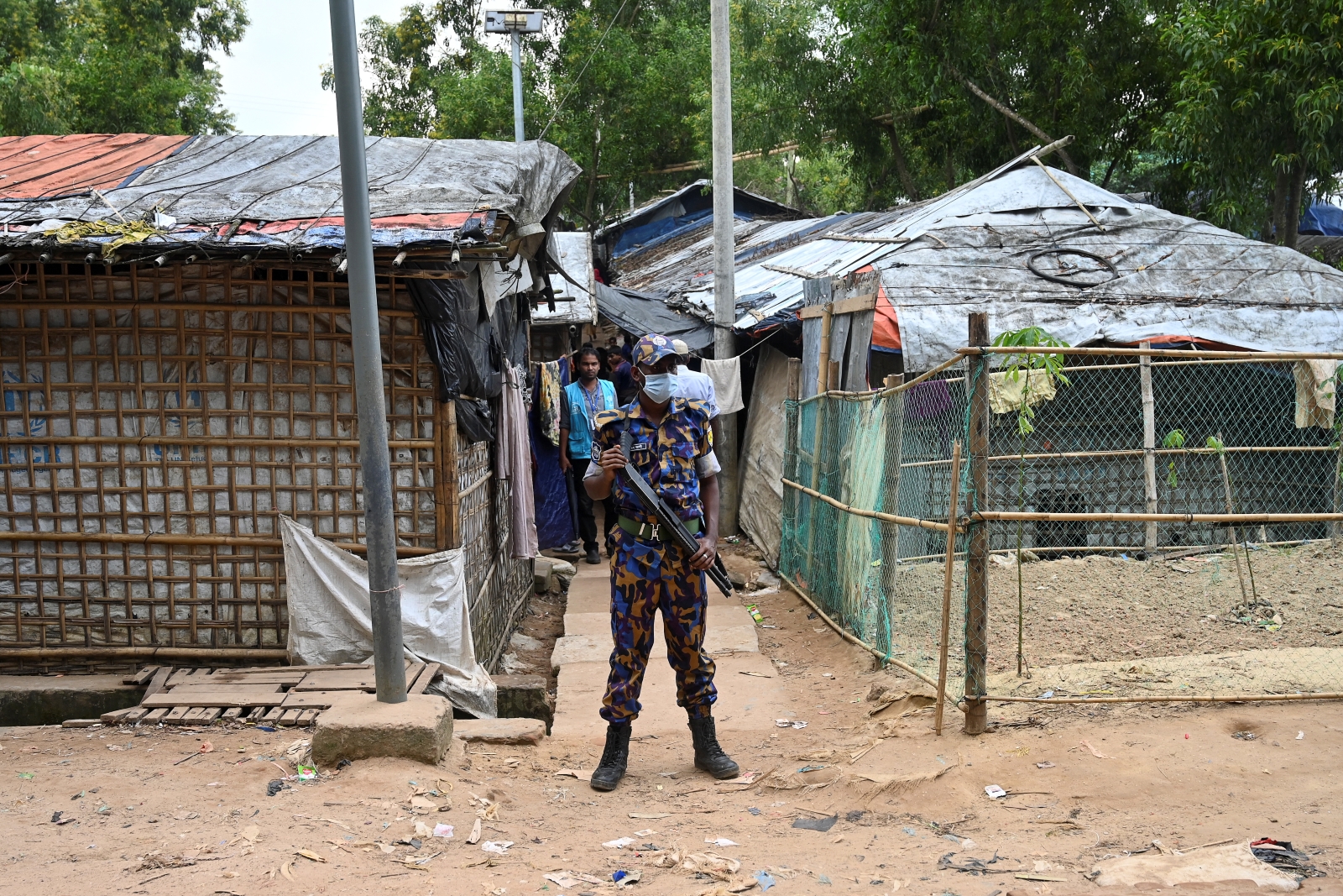 A member of Bangladesh’s Armed Police Battalion stands guard near the office of slain community Rohingya leader Mohib Ullah, believed to have been killed by Arakan Rohingya Salvation Army militants in September 2021, at the Kutupalong refugee camp in Cox’s Bazar district on October 6, 2021. (AFP)