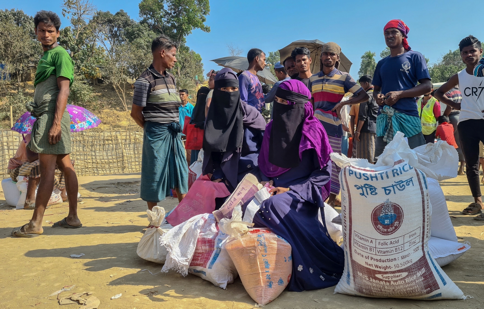 Rohingya refugees gather to collect relief materials from a distribution point in the Kutupalong camp in Bangladesh's Cox's Bazar district on March 6. (AFP)