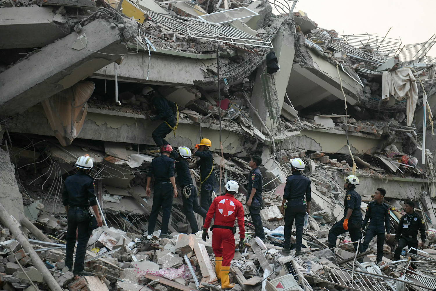 Rescuers search for survivors trapped in the collapsed Sky Villa Condominium building in Mandalay on March 29, a day after an earthquake struck central Myanmar. (AFP)
