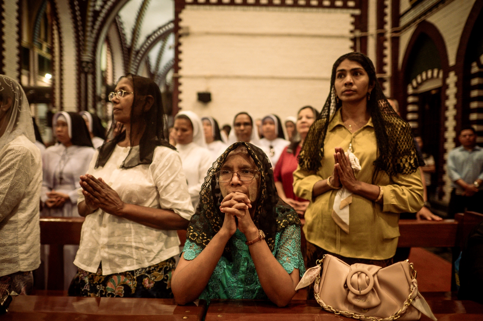 Catholics pray in memory of the late Pope Francis at St Mary’s Cathedral in Yangon on April 22. (AFP)