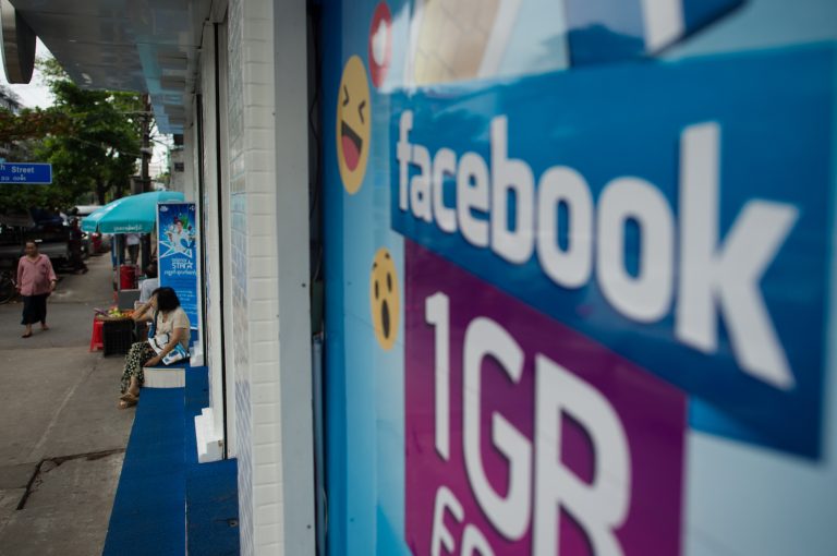 The Facebook logo is seen on an advertisement by a telecom company in Yangon in June 2018. (AFP)