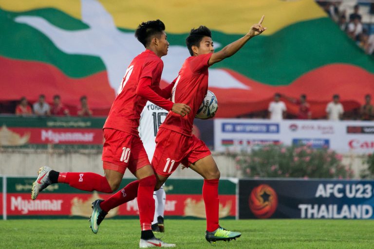 Myanmar's Hein Htet Aung, right, celebrates scoring during the Tokyo 2020 Olympic Games men's Asian qualifier football match between Myanmar and East Timor in Yangon on March 22, 2019. (AFP)