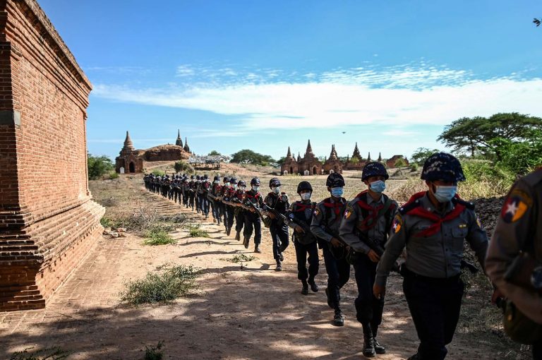 Members of a police squad patrol pagodas in a temple complex in Bagan, Mandalay Region, on June 23. (AFP)