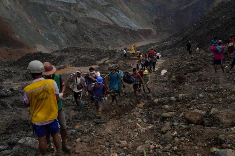 Rescuers recover bodies near the landslide at the jade mining site in Hpakant, Kachin State on July 2. (AFP)