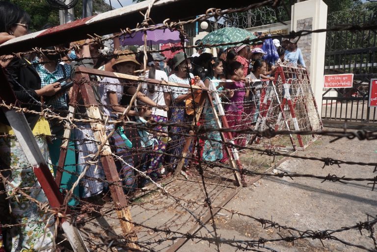 Relatives wait in front of the Insein Prison for the release of prisoners in Yangon on April 17, 2022. (AFP)