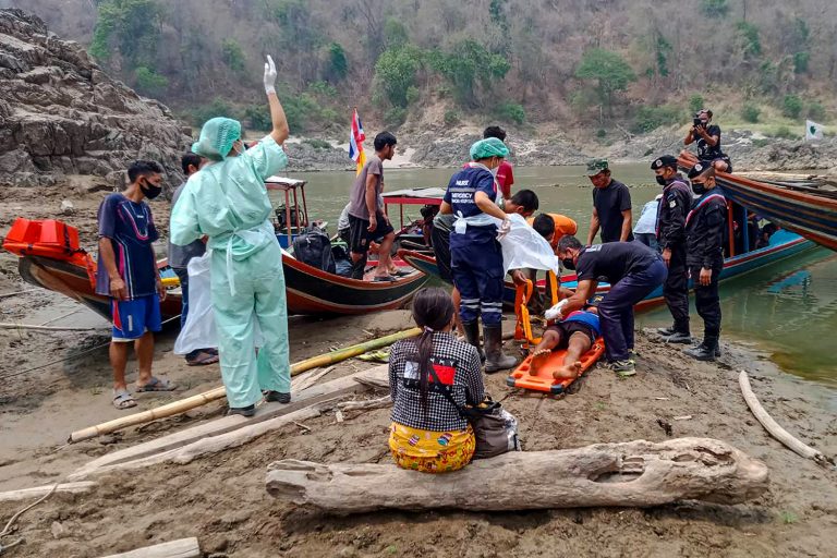In this file handout from the Royal Thai Army taken in March 2021, an injured Myanmar refugee is carried on a stretcher  after crossing the border while fleeing from air strikes in Kayin State (ROYAL THAI ARMY / AFP)
