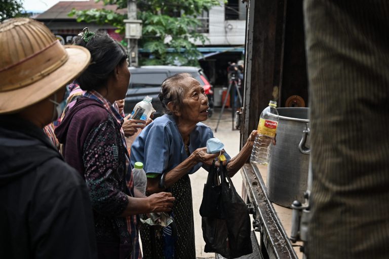 People queue to buy subsidised edible oil in Yangon on August 18. Junta policy decisions have caused the price of basic goods to skyrocket. (AFP)