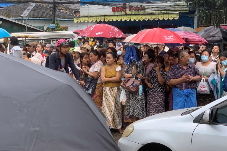 Relatives stand outside Insein Prison as they wait for the release of prisoners in a National Day amnesty. (AFP)