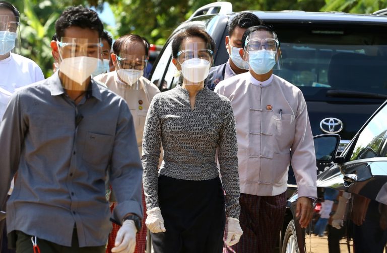 State Counsellor Daw Aung San Suu Kyi Daw in COVID-19 protective gear leaves an inspection of safety protocols for voting at a district election sub-commission in Nay Pyi Taw on October 20. (AFP)