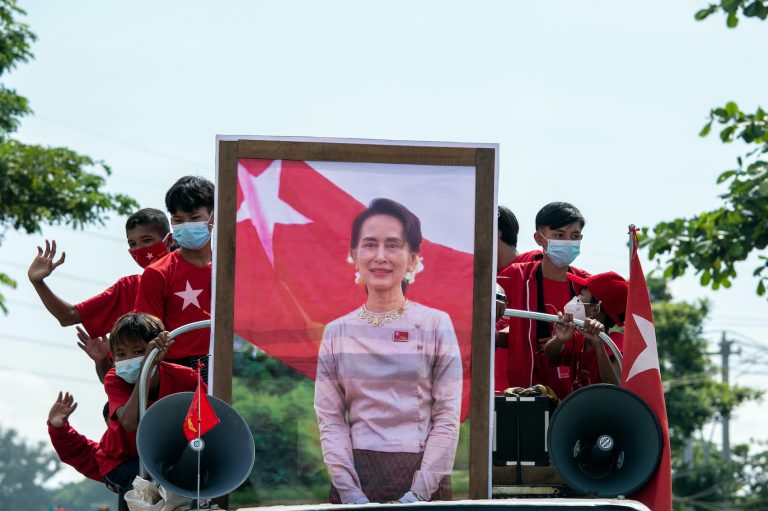 Children in National League for Democracy t-shirts take part in a campaign convoy behind a portrait of party leader Daw Aung San Suu Kyi in Yangon on October 25. (AFP)