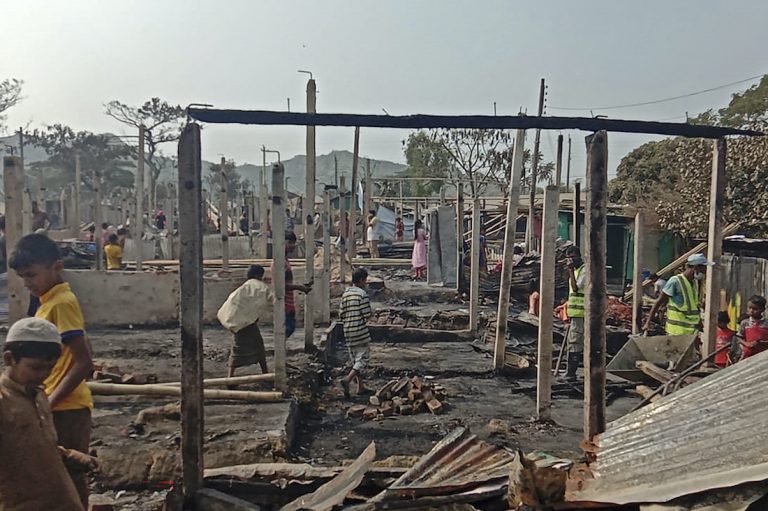 Rohingya refugees search for their belongings after a fire broke out at Nayapara refugee camp in Teknaf on January 14, 2021. (AFP)