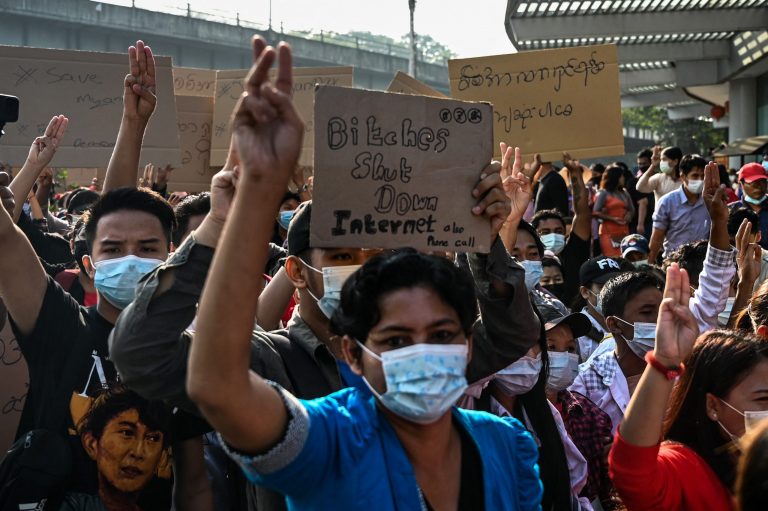 Protesters in Yangon hold placards denouncing the military's shutdown of the internet following the February 1 military coup. (AFP)