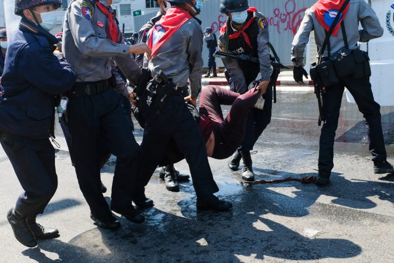 Police carry a protester as they arrest her during a demonstration against the military coup in Mandalay on February 9, 2021. (AFP)