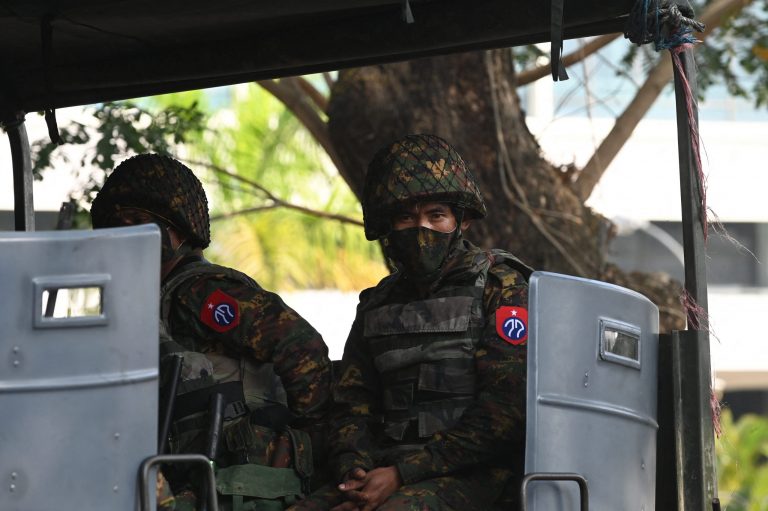 Soldiers sit in an army truck outside the Central Bank of Myanmar,in Yangon on February 15, 2021. (AFP)