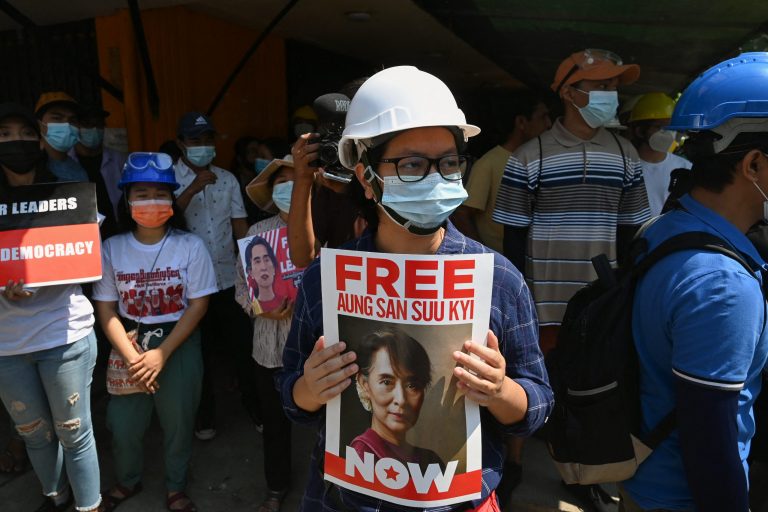 A protester holds a sign calling for the release of detained Myanmar civilian leader Aung San Suu Kyi during a demonstration against the military coup in Yangon on March 7. (AFP)