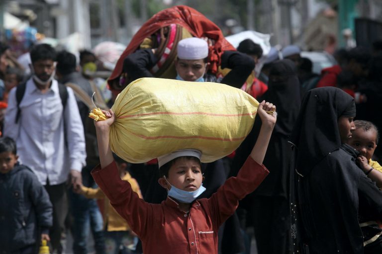 Rohingya refugees carry their belongings as they leave a Rohingya refugee camp in Jammu on March 7, 2021. (AFP)