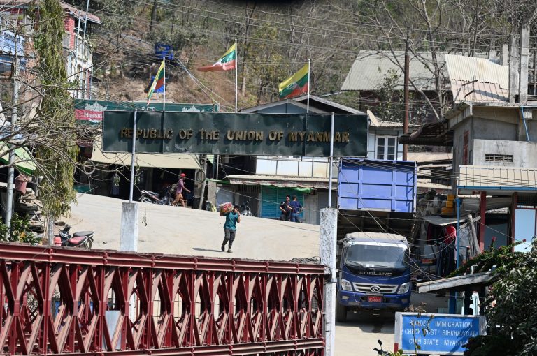 A resident carries a box on his shoulder on the Myanmar's side at the Zokhawthar border in the India's northeastern state of Mizoram on March 15, 2021. (AFP)