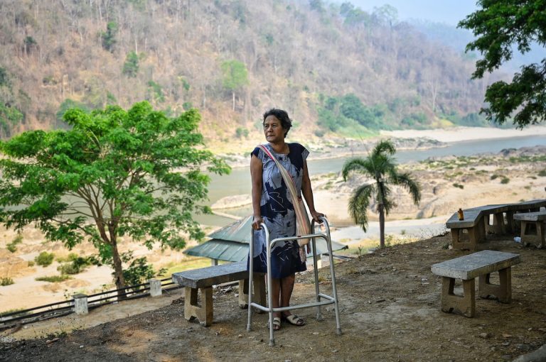 Hkara, an ethnic Karen resident of Mae Sam Laep town, in Thailand, walks alongside the Salween River in Mae Hong Son province on March 31, across from where Myanmar refugees earlier attempted to cross the Thai-Myanmar border after air strikes in Karen State. (AFP)