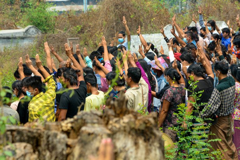 Mourners making the three-finger salute on April 8, 2021 while attending the funeral of Arkar Thu Aung, a protester who was shot dead by security forces at a demonstration against the military coup in Kale. (Handout/AFP)