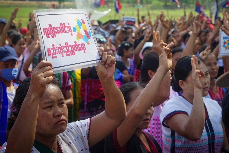 Protesters raise the three-finger salute during a demonstration against the military coup in an area under the control of the Karen National Union in Kayin State on April 22. (AFP / KNU DOOPLAYA DISTRICT)