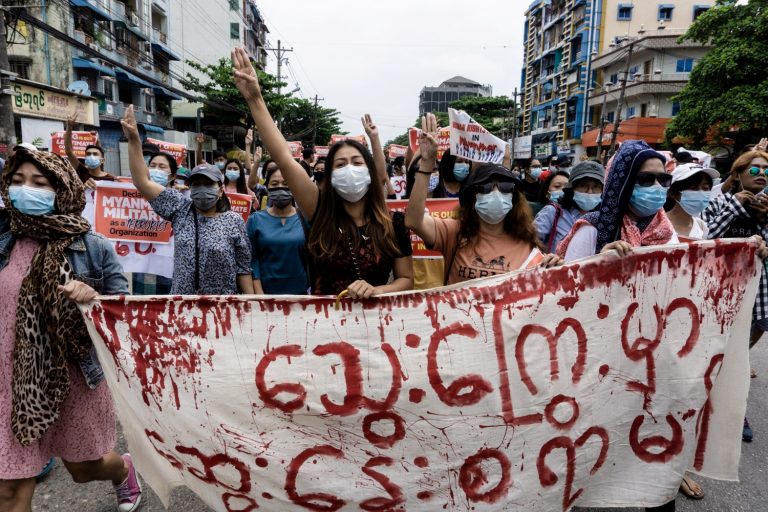 Anti-coup protesters give the three-finger salute as they march through Yangon's Thingangyun Township on April 30. (AFP)