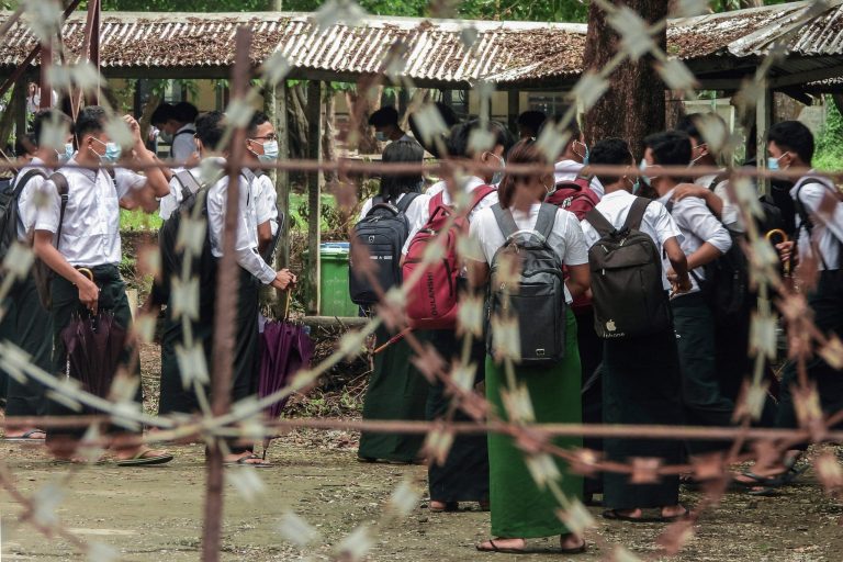 Students wait outside classrooms in Sittwe, capital of western Rakhine State on June 1, 2021. - Schools in Myanmar opened on June 1 for the first time since the military seized power, but teachers and students are set to defy the junta's calls for full classrooms in a show of resistance. (Photo by STR / AFP)