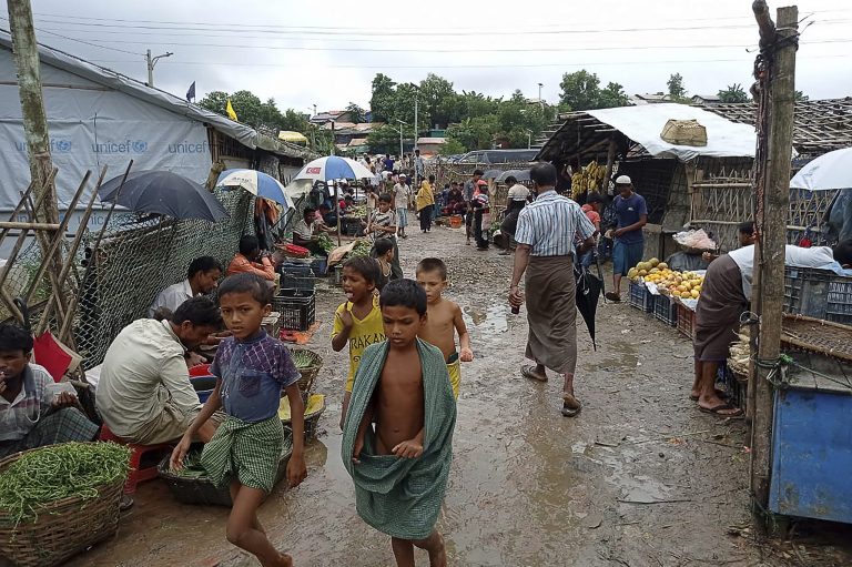 Rohingya refugees walk along a path at Kutupalong refugee camp in Ukhia on August 25, 2021. (AFP)